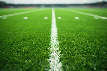Zelfklevend Fotobehang American football field, green grass with white field lines. Close-up photo © nakarin