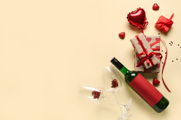 Bottle of wine with glasses, gifts and decor on yellow background. Valentine's Day celebration
