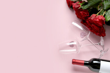 Bottle of wine with glasses and red roses on pink background. Valentine's Day celebration