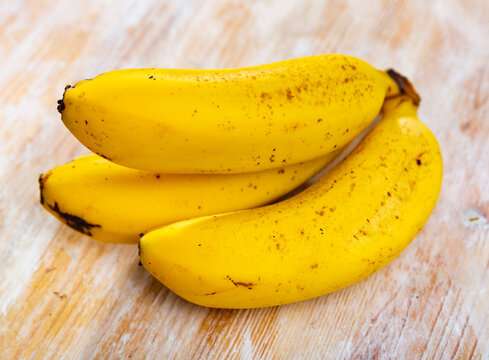 Image of bananas, ripe, tasty, lying on surface.