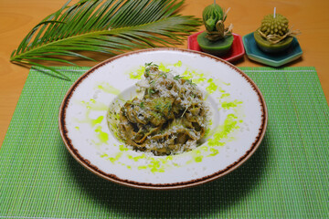 Italian tortellini pasta in cream sauce.with spinach. White wooden background. Top view