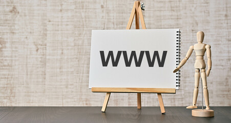 There is wood block with the word WWW. It is an abbreviation for World Wide Web as eye-catching...