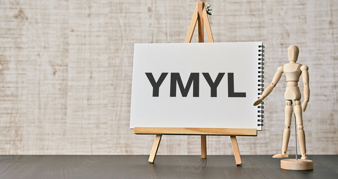 There is wood block with the word YMYL. It is an abbreviation for Your Money or Your Life as eye-catching image.