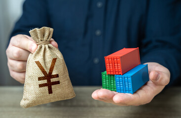 Shipping containers and chinese yuan or japanese yen money bag. Economic growth, production and...