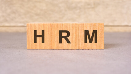 hrm acronym concept on cubes, gray background, selective focus