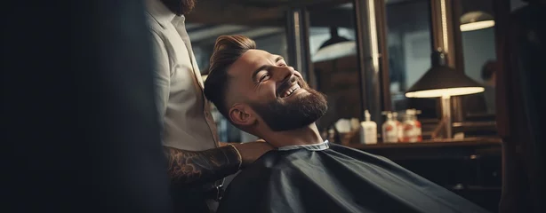 Poster Im Rahmen Attractive happy man smiling while getting a new trendy haircut or hairstyle with a professional male barber © wojciechkic.com