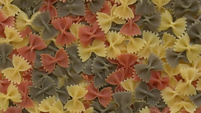 Italian tricolore farfalle pasta background.  Table spin. 