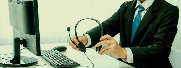 Business people wearing headset working in office to support remote customer or colleague. Call...