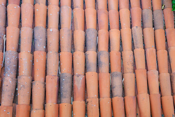 Antique clay roof made of semicircular tiles. Background with selective focus and copy space