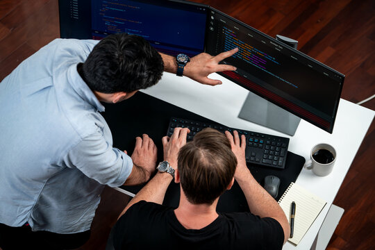 IT developers discussing online software development information on pc screen, creating program coding for latest version application on website. Concept of brainstorming firmware updated. Sellable.