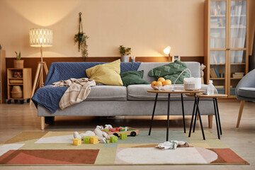 Wide shot of messy living room with big cozy couch and medical equipment on small tables, sick child concept