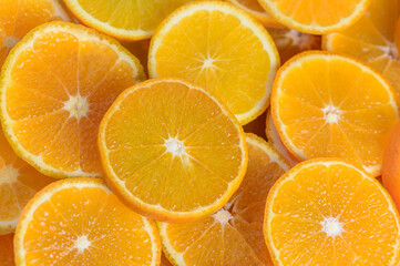 juicy tangerines cut into circles as a background 1