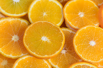 juicy tangerines cut into circles as a background 2