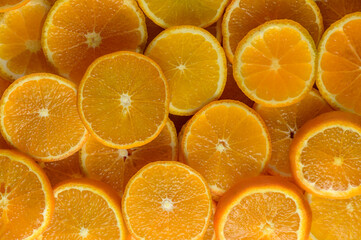juicy tangerines cut into circles as a background 16