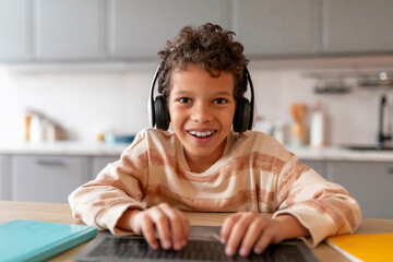 Pov Shot Of Little Black Boy In Headset Using Laptop At Home