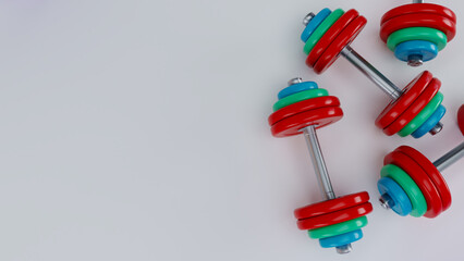 3D render of realistic colored dumbbells isolated on white background.