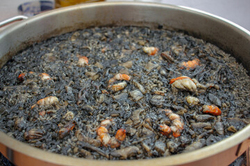 shrimps and squids in a black rice