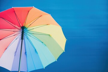 Rainbow umbrella on a blue background with raindrops Ai Generative