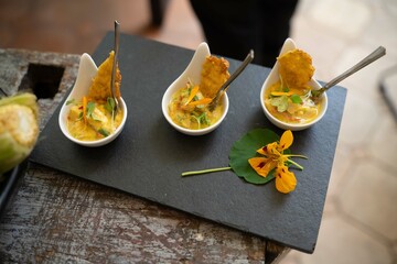 three small samples of yellow ceviche on slate graphite surface in peruvian restaurant © Aon Prestige Media