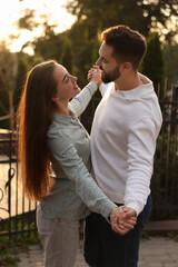 Lovely couple dancing together outdoors at sunset