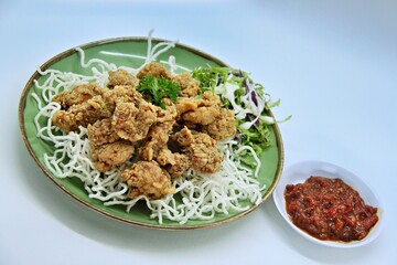 ayam goreng kering is an indonesian food crispy fried chicken with hot and spicy sambal chili sauce. delicious homemade crispy fried chicken. crunchy fried chicken ready to eat.