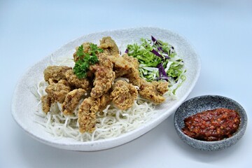 ayam goreng kering is an indonesian food crispy fried chicken with hot and spicy sambal chili sauce. delicious homemade crispy fried chicken. crunchy fried chicken ready to eat.