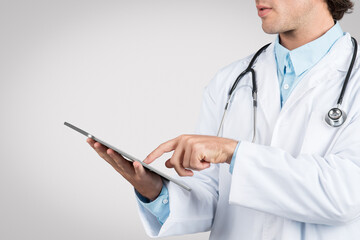 Doctor man using tablet, partial profile view