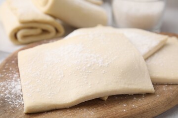 Raw puff pastry dough on table, closeup