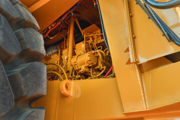 Obraz na płótnie Canvas close up engine yellow mining truck and huge tire