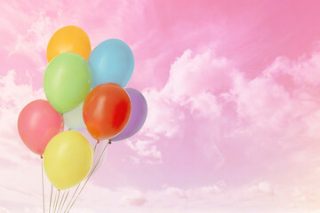 Colorful balloons flying in pink sky with clouds, color toned. Space for text