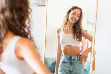 Happy Young Teen Age Girl Wearing Jeans After Dieting Indoors - obrazy, fototapety, plakaty