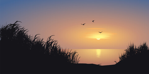 Beautiful minimal sunrise landscape with seaside, grass and flying birds