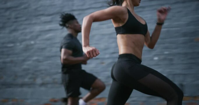 Man, woman and running in city for fitness wellness or cardio athlete, sports or exercise. Female person, personal trainer and jogging challenge as friends or outdoor physical activity, race or speed