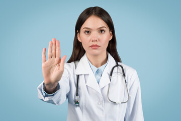 Doctor woman gesturing stop with a serious expression