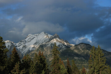 Sunlit Mountain with Dark Clouds