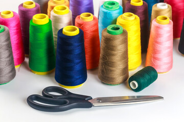 Spools of thread in various colors for sewing machine.