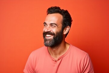 Portrait of a handsome man with beard and mustache on orange background