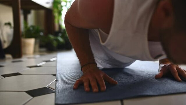 Man, friends and hands in yoga for workout, exercise or training together on living room floor at home. Closeup of male person, people or yogi legs in pose, pilates or morning routine on mat at house