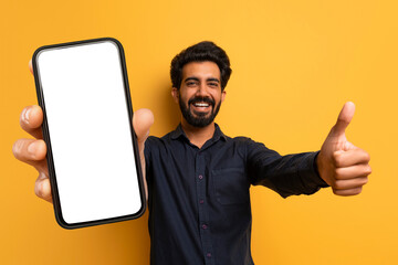 Cheerful Happy Indian Man Showing Thumb Up And Phone