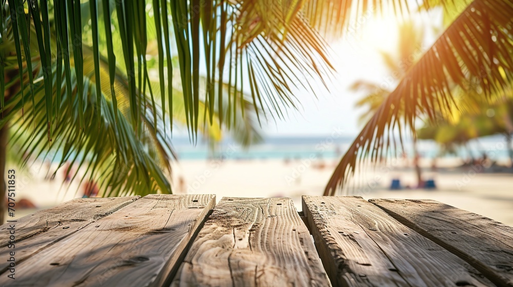 Poster empty wooden table and palm leaves with party on beach blurred background in summer time.