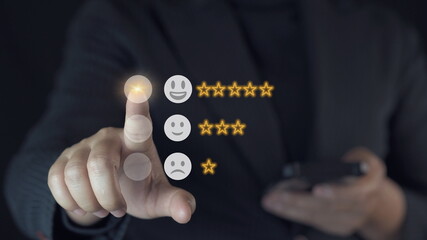 Businessman touching smile face icons and info graphic to evaluate product after use service , customer satisfaction concept.