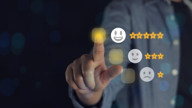 Best excellent business services rating customer experience. Satisfaction survey concept. Hand of a businessman chooses a smiley face on wood block cube. 5 Star Satisfaction