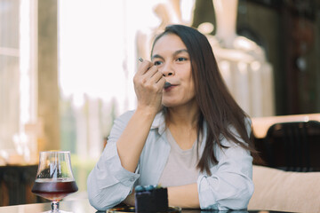 Young woman is happy and enjoys eating sweets and coffee at a cafe.