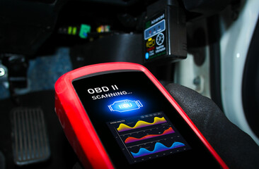 Auto mechanic checking ECU engine system with OBD2 wireless scanning tool and car information showing on screen interface , Car maintenance service concept.