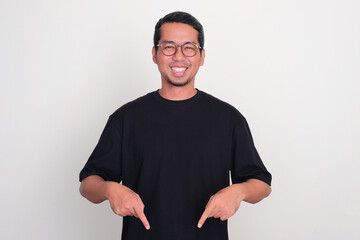 Adult Asian man smiling happy with both hands pointing below