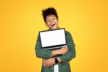 Overjoyed black guy hugging laptop with white blank screen - obrazy, fototapety, plakaty