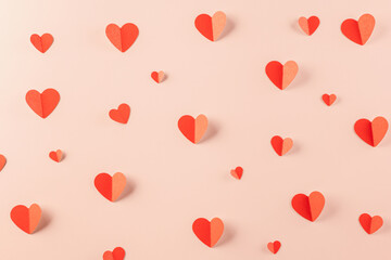 Happy Valentine Day concept. Beautiful red paper hearts shape cutting pastel pink background,...