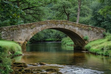 Fototapeta na wymiar Old stone bridge arching over a peaceful river