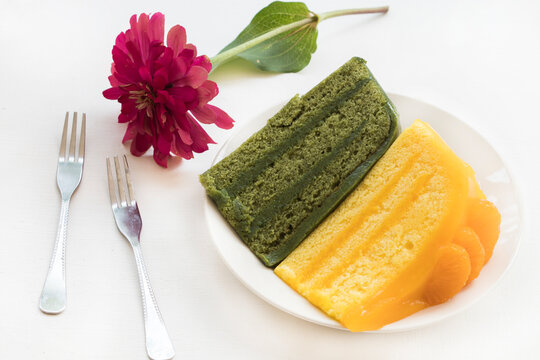 orange, green tea cake dessert snace delicious with flower arrangement flat lay style on background white 