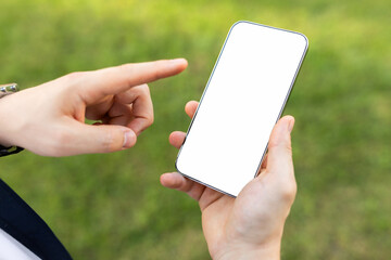Close-up of a person's hands holding a smartphone with a blank white screen